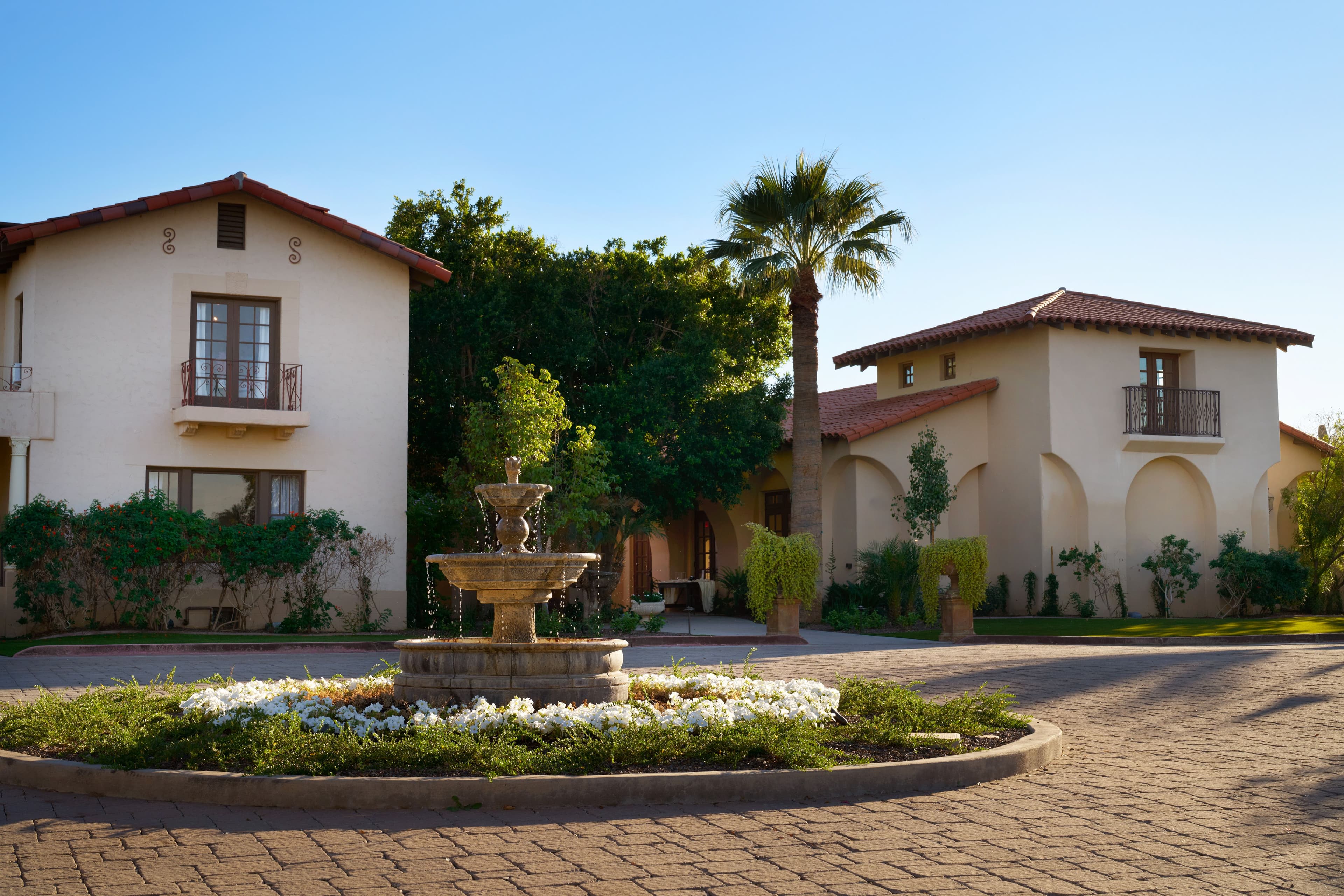 Scenic exterior view of the Spanish-style villa and fountain at Secret Garden by Wedgewood Weddings.